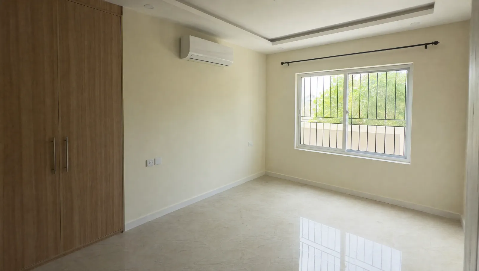 AI-generated illustration of an empty, clean, newly finished bedroom in a Karachi house with a grilled window and marble-effect floor.